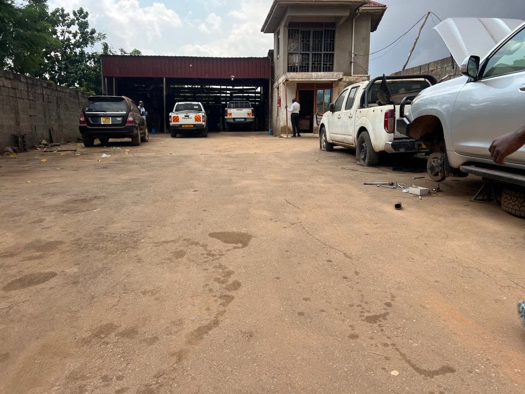 Covered service bay with vehicles at Lawrebac Auto Garage